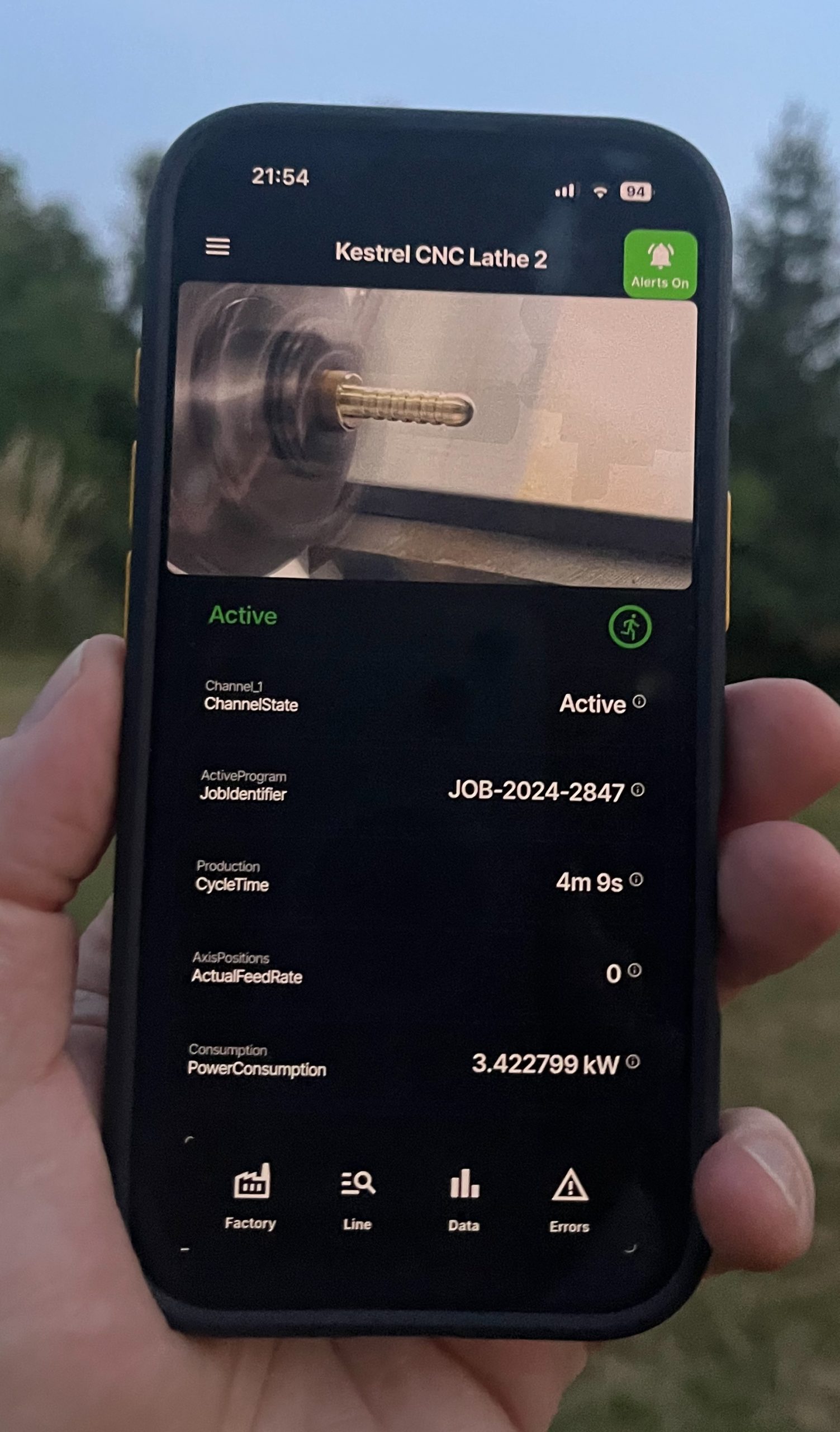 RoboVigil app showing a live feed of a CNC lathe on a phone